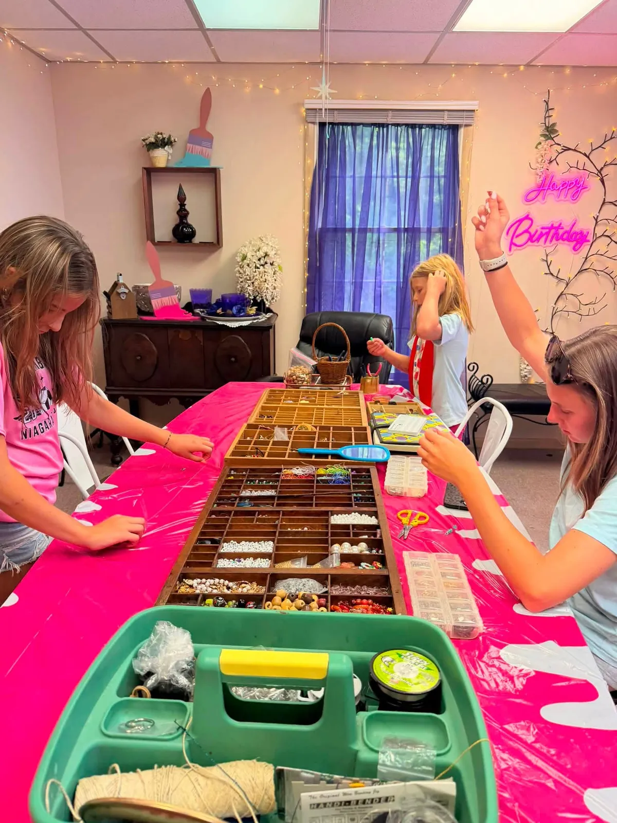 Students of different ages working side by side at the bead and jewelry table during an art class at InDreams Art Experience in Medford, NJ