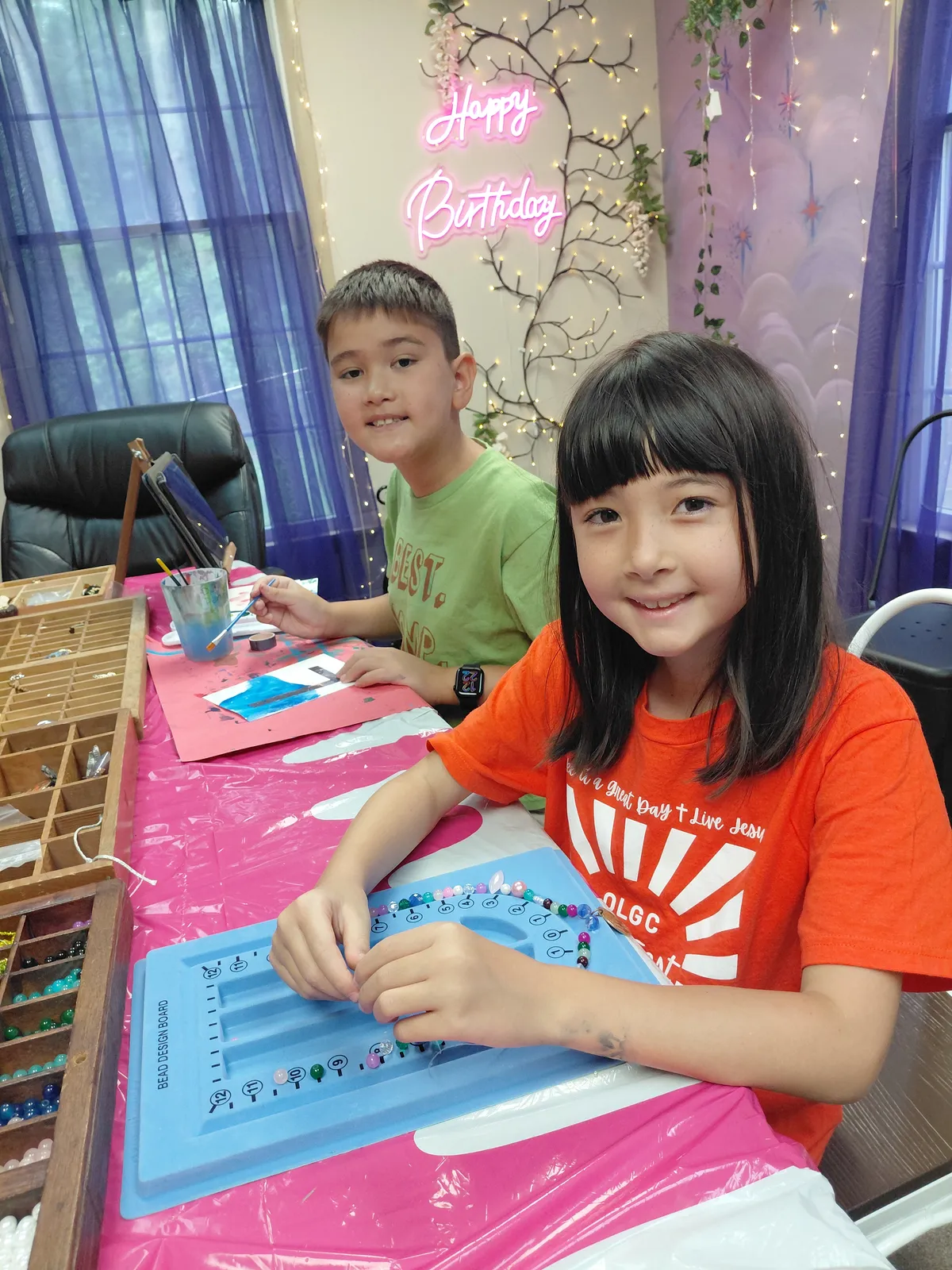 Two children stringing beads on a bead board during a jewelry making class at InDreams Art Experience in Medford, NJ