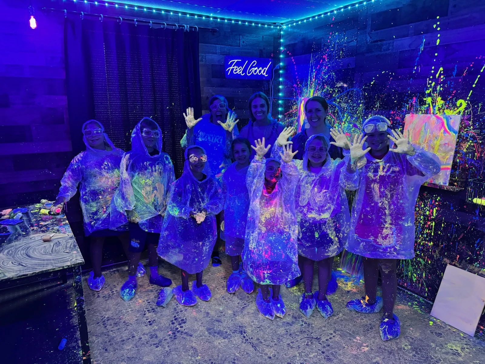 Guests enjoying a glow splatter paint birthday party