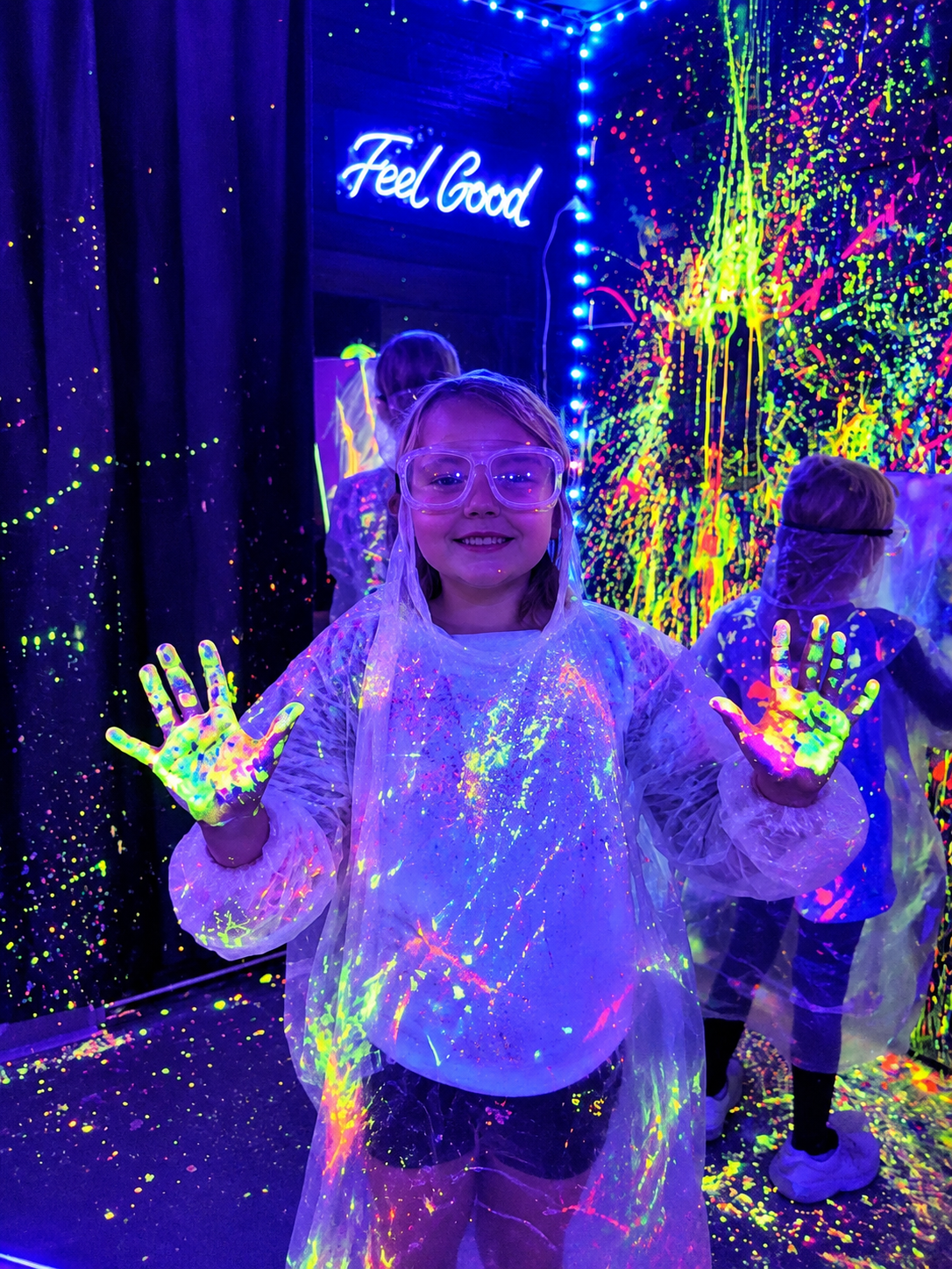 Children enjoying the neon glow splatter paint room at InDreams Art Experience